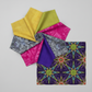 What If Radio Star Purple/Multi fabric flat with coordinating quilting fabric pinwheel fan featuring What If, Interwoven, and Needle Stars collection fabrics by Paula Nadelstern for Benartex