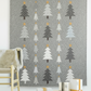 Essentials Connect The Dots Gray quilting cotton by Susan Winget for Wilmington Prints — styled in a cozy Scandinavian living room as the background of a modern Christmas tree wall hanging quilt with geometric stacked trees in grey, charcoal, and cream with gold stars, wrapped gifts below
