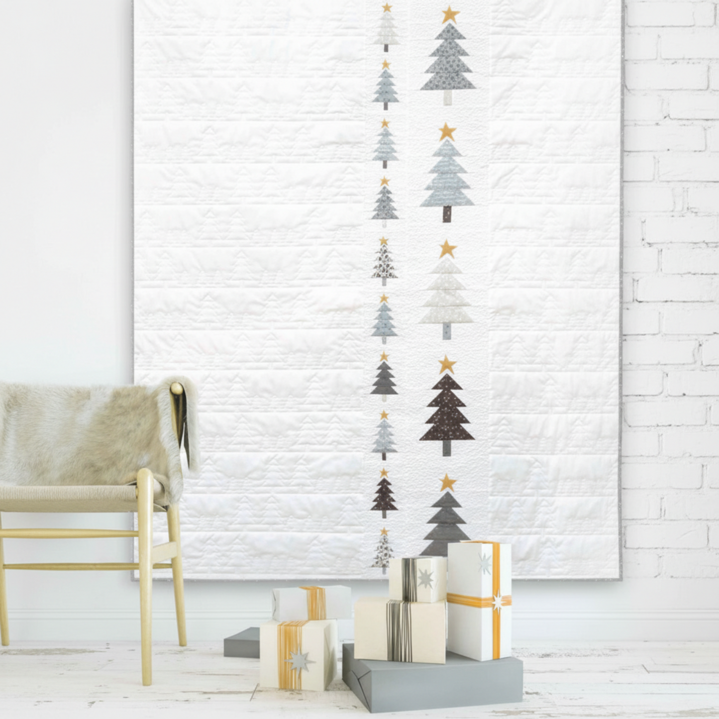 Essentials Connect The Dots Gray quilting cotton by Susan Winget for Wilmington Prints — pictured as the background in a modern Scandinavian Christmas tree wall hanging quilt with geometric stacked trees in grey, charcoal, white, and cream with gold star accents