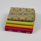 What If Good Vibes Gold/Multi coordinated with Interwoven Citron, Marigold, and Magenta quilting cottons and What If Radio Star Red/Multi — Paula Nadelstern for Benartex