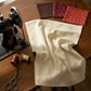 Scraps of Kindness Cream Nine Patch Boxes quilting cotton by Kim Diehl for Henry Glass — styled sewing room flat lay with fabric alongside vintage sewing machine, dark brown and cream thread spools, scissors, thimble, and dark brown, burgundy, and red fabric swatches