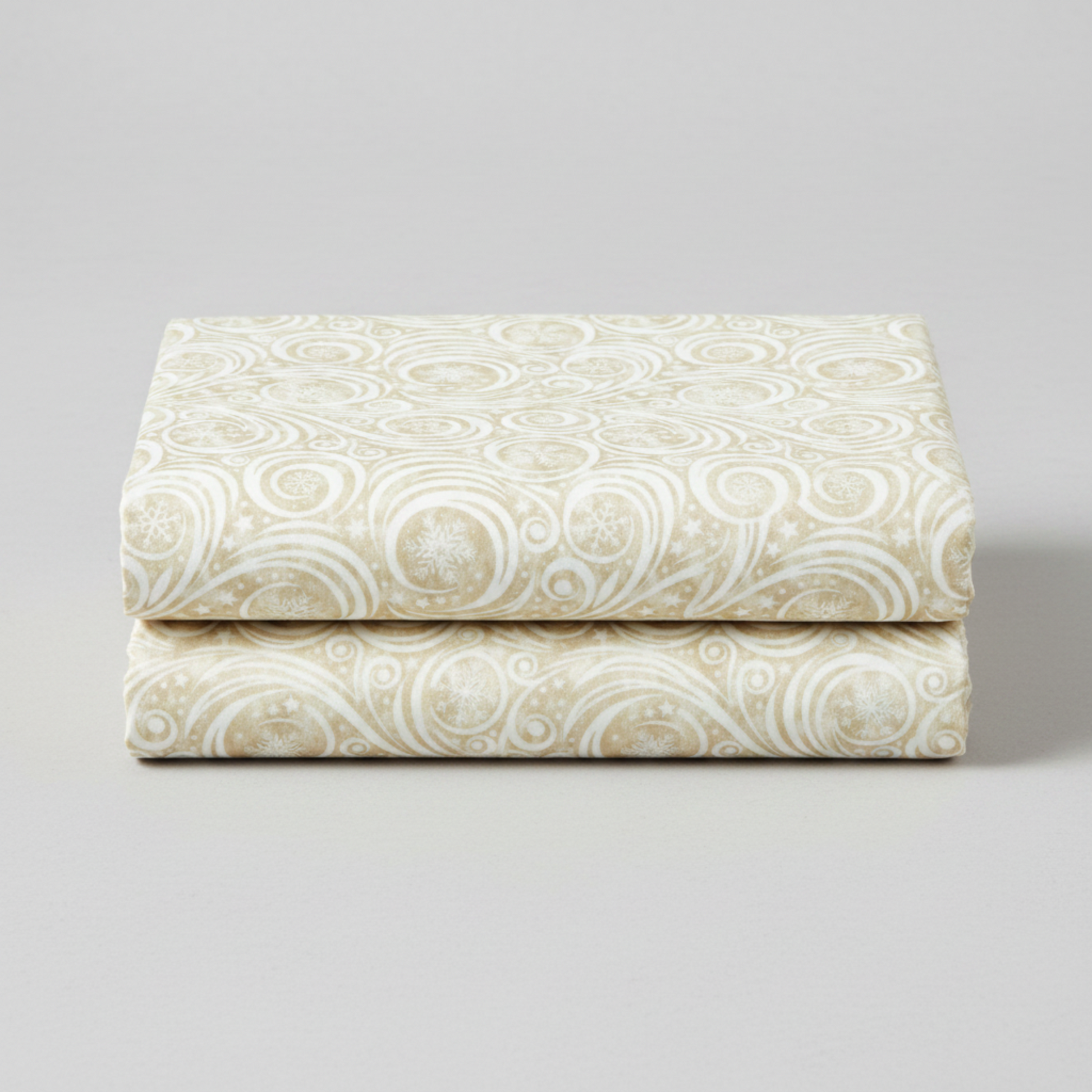 Winter Solstice II Cream Snow Swirl quilting cotton by Jason Yenter for In The Beginning Fabrics — three folded yards stacked on a grey surface showing tone-on-tone pearl white scroll swirls with snowflakes and scattered stars on warm ecru mottled ground. Coordinating fabrics and quilt patterns are available at IraRobi Quilts.