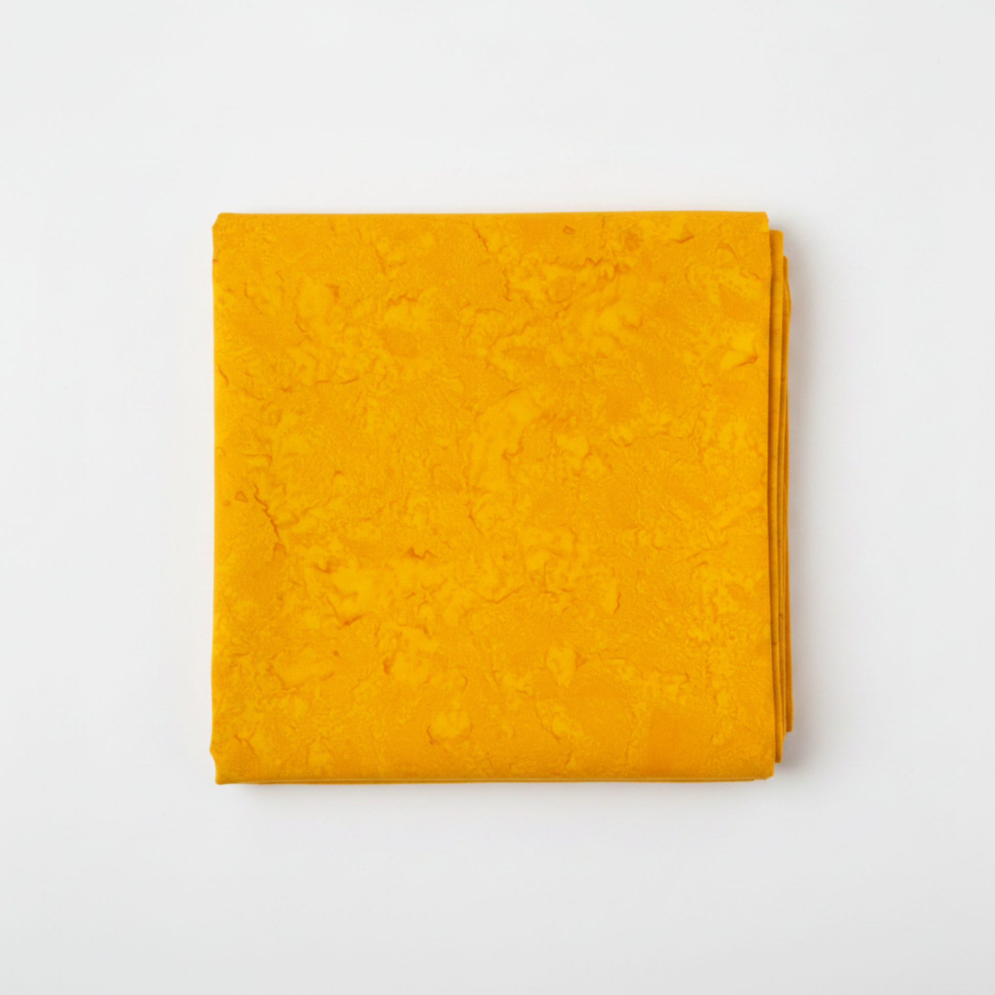 Expressions Batiks Hand-Dyes Curry quilting cotton fabric by Riley Blake Designs folded into a neat square showing rich deeply saturated curry yellow hand-dyed batik with warm golden tones and subtle organic light-to-dark tonal shifts – a bold single-hue tonal blender, 100% cotton batik, 43–44" wide