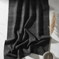 Deep dark charcoal Interwoven geometric crosshatch quilting fabric draped on white marble in a minimal modern setting. Interwoven Dark Slate by Jason Yenter for In The Beginning Fabrics – shop fabric at IraRobi Quilts | #quiltingfabric #darkfabric #modernquilt #geometricfabric #inthebeginning