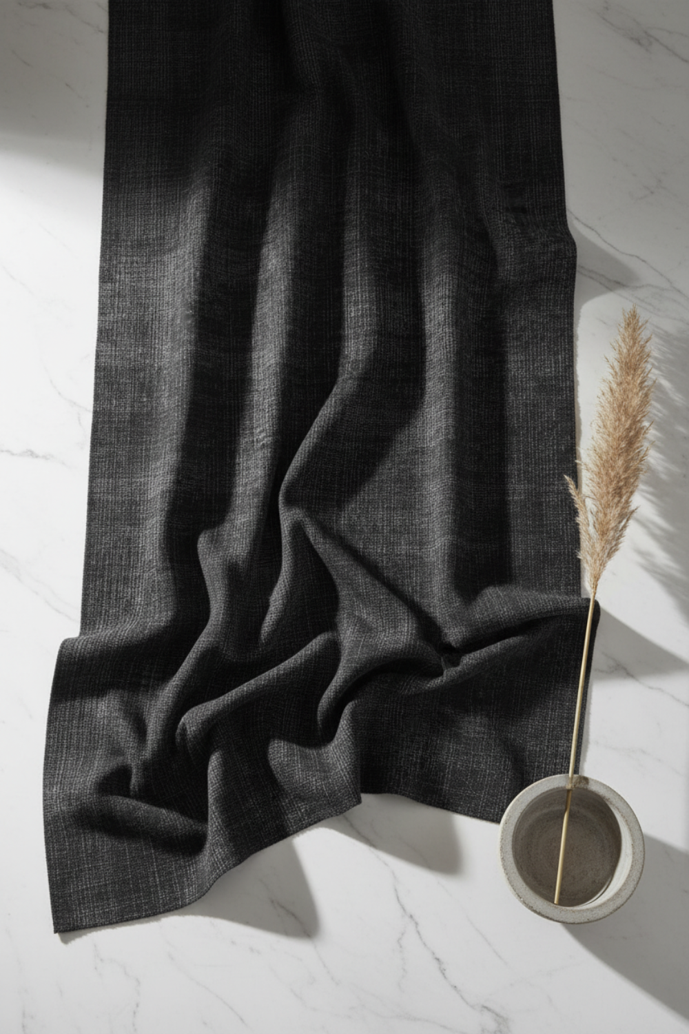 Deep dark charcoal Interwoven geometric crosshatch quilting fabric draped on white marble in a minimal modern setting. Interwoven Dark Slate by Jason Yenter for In The Beginning Fabrics – shop fabric at IraRobi Quilts | #quiltingfabric #darkfabric #modernquilt #geometricfabric #inthebeginning