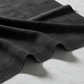 Interwoven Dark Slate quilting fabric draped on white marble – deep dark charcoal geometric crosshatch texture with crisp modern styling – 100% cotton quilting fabric by Jason Yenter for In The Beginning Fabrics