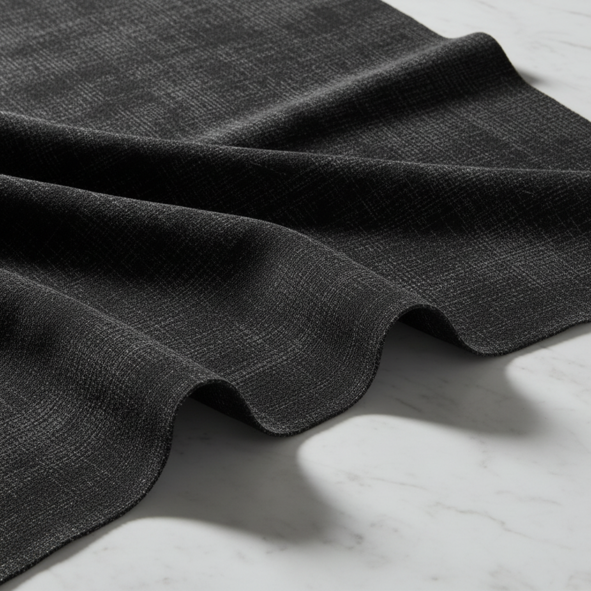 Interwoven Dark Slate quilting fabric draped on white marble – deep dark charcoal geometric crosshatch texture with crisp modern styling – 100% cotton quilting fabric by Jason Yenter for In The Beginning Fabrics