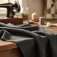 Deep dark charcoal Interwoven geometric crosshatch quilting fabric draped to show subtle woven texture and tonal variation. Interwoven Dark Slate by Jason Yenter for In The Beginning Fabrics – shop fabric at IraRobi Quilts | #quiltingfabric #darkfabric #geometricfabric #inthebeginning #modernquilt
