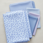 Daydreams Blue Tonal Leaves fabric by Jason Yenter for In The Beginning Fabrics folded on a linen surface – delicate ditsy leaves in soft periwinkle and lavender on dreamy cornflower blue watercolor ground, perfect for spring and blender quilt projects, digitally printed, 100% cotton, 3 yard cut