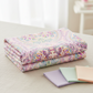 Daydreams Multi Floral Paisley fabric by Jason Yenter for In The Beginning Fabrics folded on a linen surface – ornate floral medallions and swirling paisley damask in dreamy watercolor pastels of pink, lavender, purple, and teal on soft blush ground, perfect for romantic spring quilt projects, digitally printed, 100% cotton, 3 yard cut
