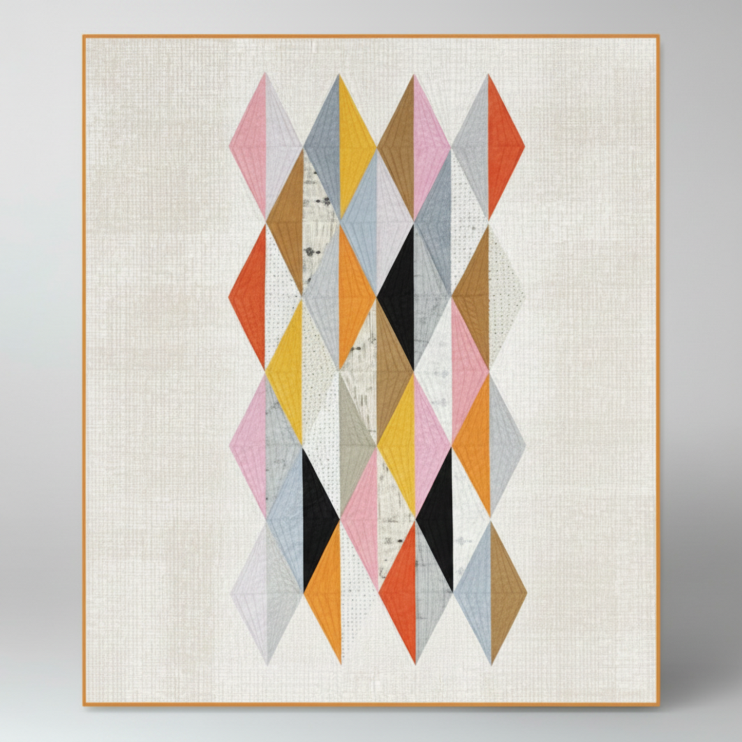 Interwoven Taupe Fabric by Jason Yenter for In The Beginning Fabrics — shown as the low-volume background fabric in the Delight Quilt Pattern by Zen Chic, elongated diamond geometric design with warm and cool accent fabrics. Quilts shown for inspiration feature the Delight Quilt Pattern by Zen Chic — available at IraRobi Quilts.