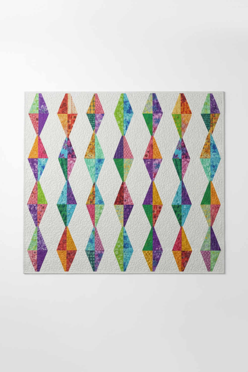 Diamond Daze quilt with vivid purple-violet Interwoven Plum as the star fabric – elongated diamond blocks on white, coordinating with periwinkle, pink, lime and butterscotch. Diamond Daze pattern by Sew Kind of Wonderful. Shop Interwoven Plum at IraRobi Quilts | #diamonddaze #quiltingfabric #jeweltone #interwoven #modernquilt