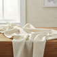 Dotty Thatched Washed Linen quilting cotton fabric draped over wood surface – warm cream dot texture blender by Robin Pickens for Moda Fabrics