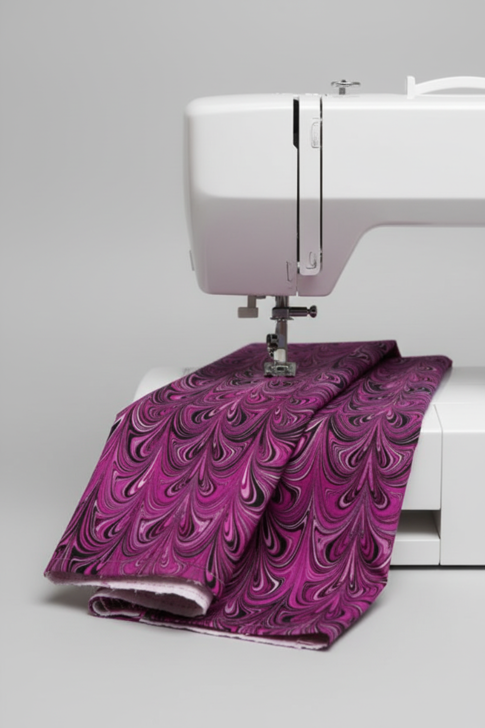 Needle Stars Chandelier Fuchsia marbled feather swirl quilting cotton draped over sewing machine — Paula Nadelstern for Benartex, 100% cotton