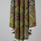 What If Good Vibes Gold/Multi quilting cotton in soft vertical drape showing fabric texture and body — bold kaleidoscopic geometric by Paula Nadelstern for Benartex