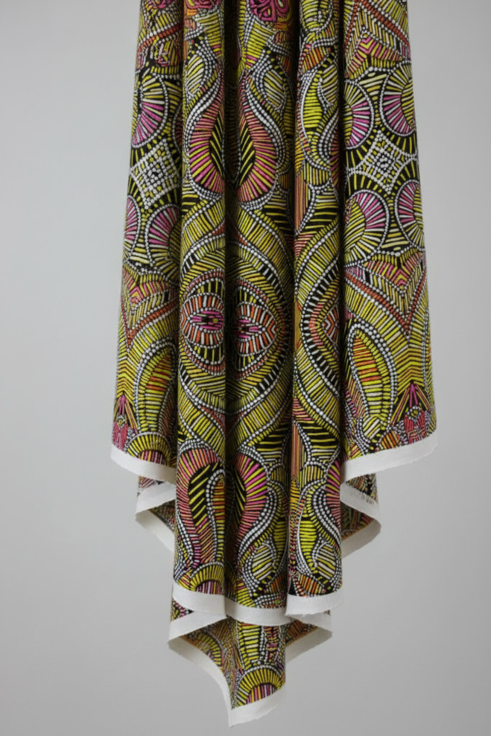 What If Good Vibes Gold/Multi quilting cotton in soft vertical drape showing fabric texture and body — bold kaleidoscopic geometric by Paula Nadelstern for Benartex