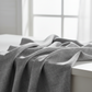 Interwoven Slate quilting fabric draped to show cool medium-grey geometric crosshatch texture and subtle tonal variation – 100% cotton quilting fabric by Jason Yenter for In The Beginning Fabrics
