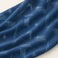 Bluish Stitched Up Blueprint quilting cotton draped in soft folds, showing pale stitched arcs and crosshatches on blue.