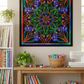 Dream Big Ethereality Paradise Quilt Panel by Jeanie Sumrall-Ajero for Hoffman Fabrics — hung as a wall quilt in a cozy quilting studio — vibrant kaleidoscope mandala in blue, green, pink, orange, and purple on black — colorful fabric rolls, thread spools, and greenery displayed below — available at IraRobi Quilts