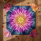 Dream Big Leaf Paradise Quilt Panel by Jeanie Sumrall-Ajero for Hoffman Fabrics — overhead flat lay on warm wood floor — pink, purple, orange, and yellow leaf mandala on navy — surrounded by fanned fat quarters at corners, wicker basket with fabric rolls, autumn leaves, and wooden thread bobbins — available at IraRobi Quilts