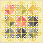 Emilia quilt pattern by Robin Pickens on a soft yellow background, featuring coral, green, and floral triangle blocks with a coordinating yellow half-square triangle border