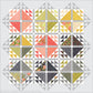 Emilia quilt pattern by Robin Pickens on a light gray background, showcasing coral, green, gold, and floral triangle blocks with a lacy half-square triangle border