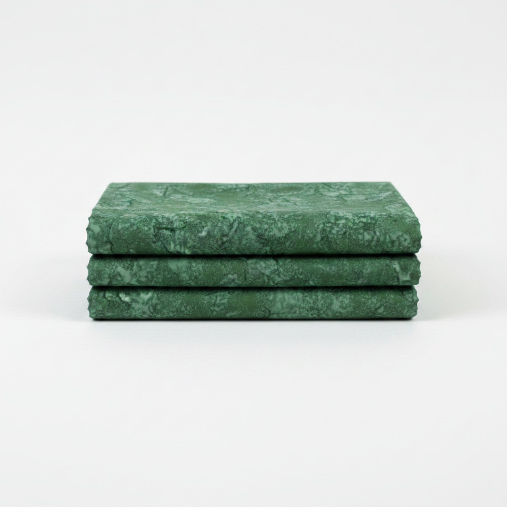 Expressions Batiks Hand-Dyes Evergreen quilting cotton fabric by Riley Blake Designs folded into a neat square showing rich deep forest green hand-dyed batik with organic tonal variation and subtle mottled texture – a versatile tonal blender with depth and sophistication, 100% cotton batik, 43–44" wide