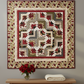 Everlasting Rose Sonata quilt hung on a grey wall above a wooden console table with red roses – stunning crimson, cream and sage green medallion quilt made from the Everlasting Rose Quilt Top Kit by Nancy's Notions featuring Cozy Quilt Designs Sonata pattern. #QuiltKit #EverlastingRose #SonataQuilt #ModernQuilting #QuiltInspiration