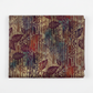 Falling Leaves Multi Leaf Stripe quilting cotton fabric folded to show large-scale botanical leaf silhouettes over vertical stripe geometric background – jewel tones of burgundy, plum, purple, teal, and burnt orange by Jason Yenter for In The Beginning Fabrics, 100% cotton, 3 yard cut