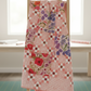Dotty Thatched Carnation quilting cotton by Robin Pickens for Moda Fabrics — shown in the Fiona's Daisy Chain Quilt Pattern by Robin Pickens draped on a wooden ladder in a bright quilting studio with coordinating Superbloom florals in pinks, purples, and reds. Quilts shown for inspiration feature the Fiona's Daisy Chain Quilt Pattern by Robin Pickens — available at IraRobi Quilts.