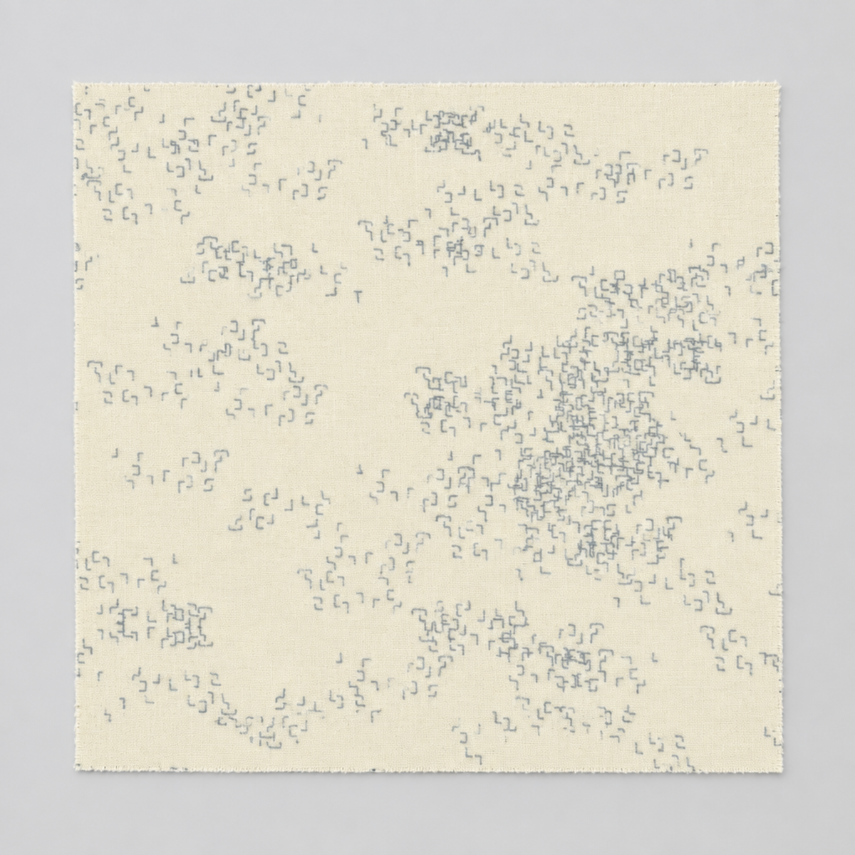 Modern Background Even More Paper Eggshell Edgy fabric by Zen Chic for Moda Fabrics, laid flat with scattered clusters of small gray angular marks on an eggshell background.