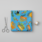 Safari Fun Playful Safari Blue quilting cotton folded flat with fabric scissors and thread spool on light grey background — whimsical tigers, leopards, monkeys, toucans, and parrots by Terry Runyan for Benartex