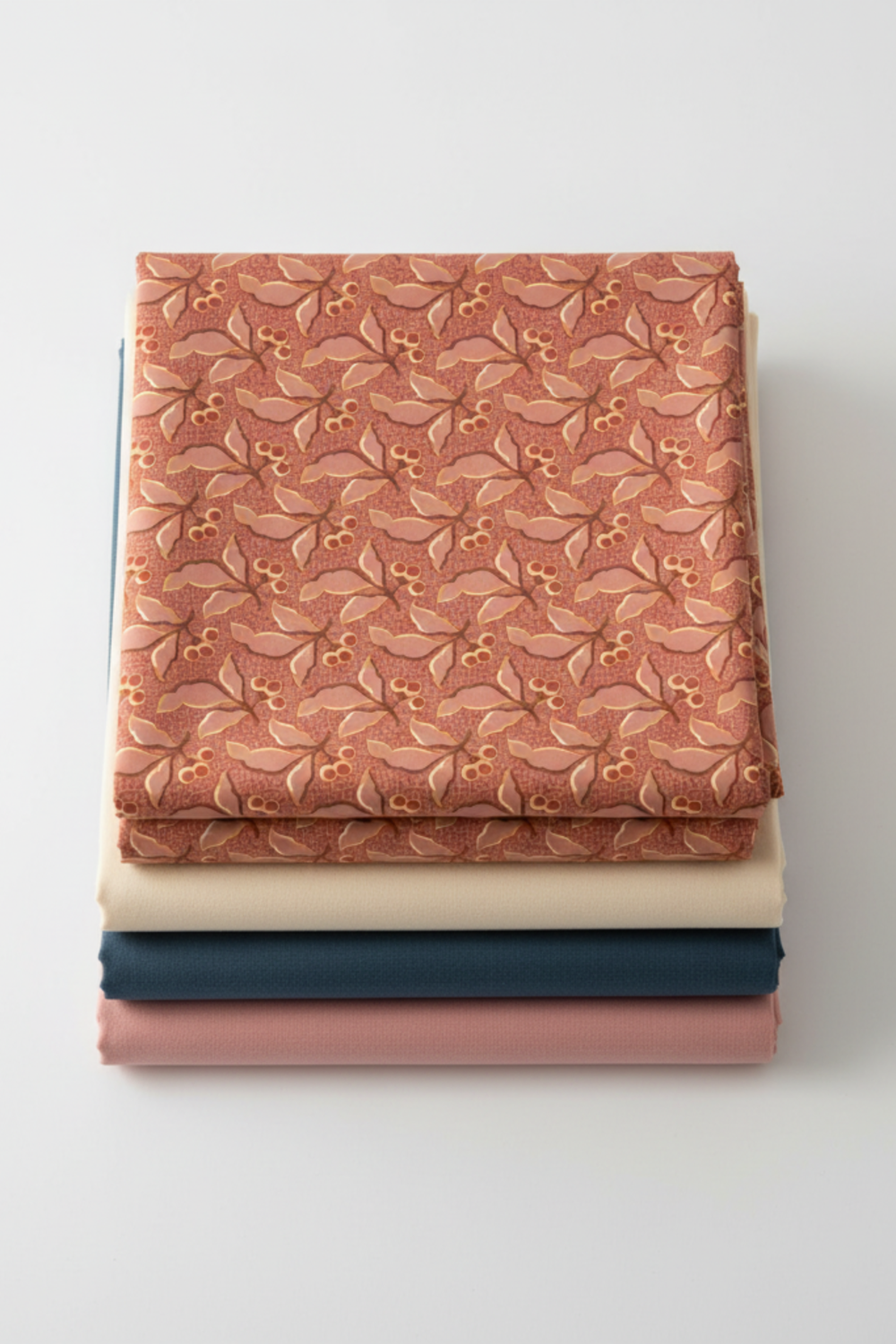 Flat lay of The Fox Homestead Pink Leaves And Berries fabric by Stacy West for Henry Glass with coordinating quilting cotton colorways