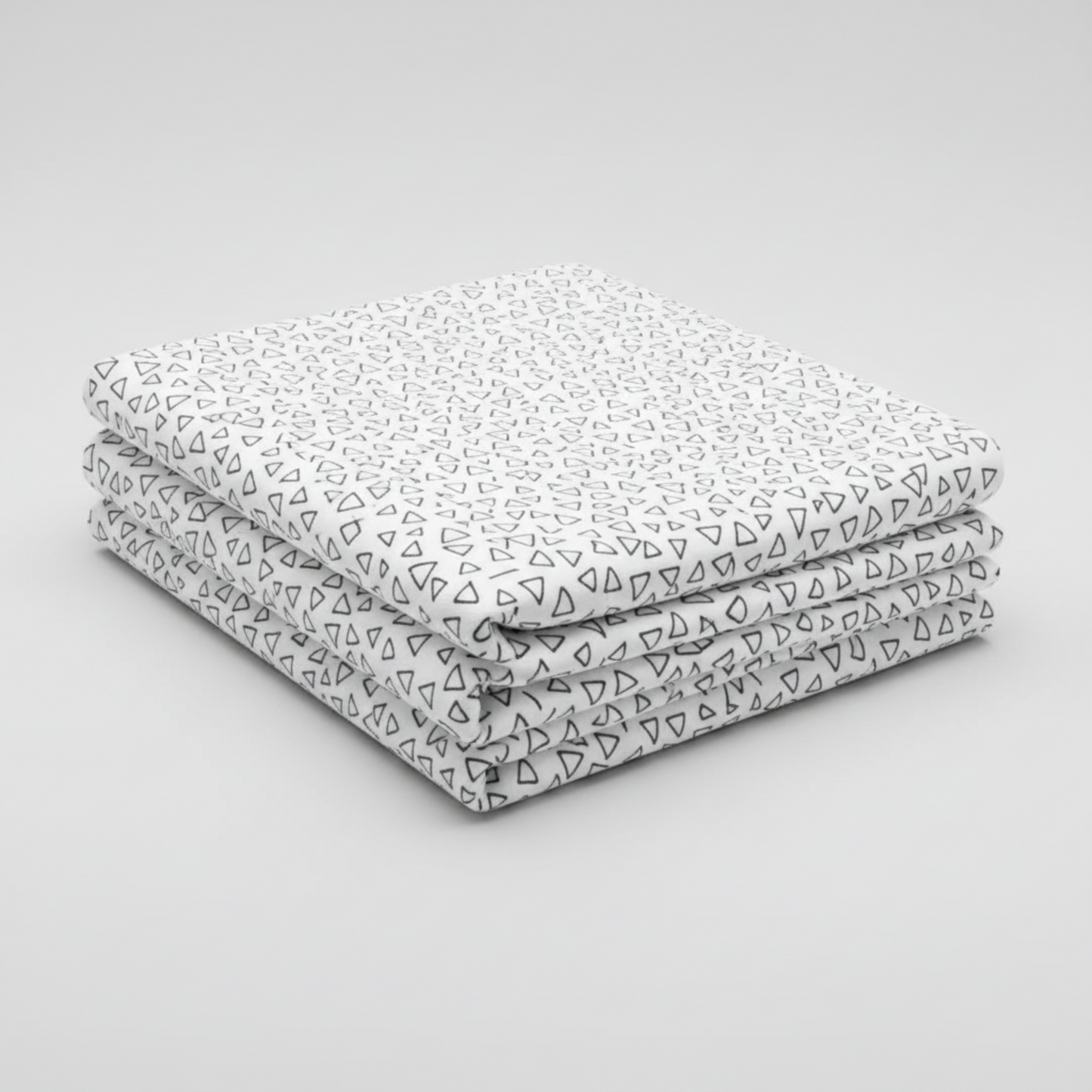 Safari Fun Floating Triangles White/Black by Terry Runyan for Benartex – neatly folded fabric stack on light grey background showing black hand-drawn triangle outlines on crisp white quilting cotton