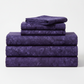 Expressions Batiks Hand-Dyes Dark Purple quilting cotton neatly folded and stacked, showing rich jewel-tone color – by Riley Blake Designs