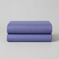 Dotty Thatched Periwinkle quilting cotton by Robin Pickens for Moda Fabrics neatly folded in a stack on a light grey background showing the dreamy periwinkle-blue ground with scattered tonal dots. 100% cotton, 43–44" wide. Available at IraRobi Quilts