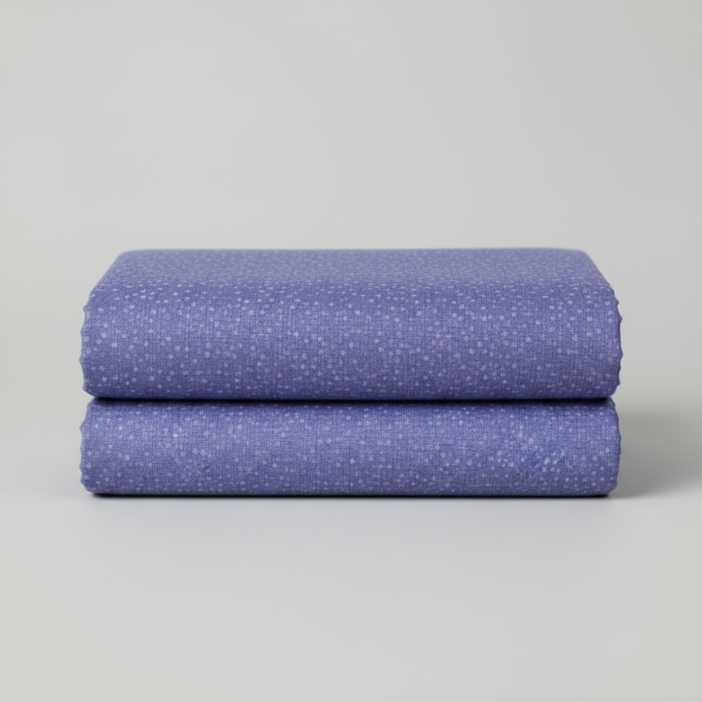 Dotty Thatched Periwinkle quilting cotton by Robin Pickens for Moda Fabrics neatly folded in a stack on a light grey background showing the dreamy periwinkle-blue ground with scattered tonal dots. 100% cotton, 43–44" wide. Available at IraRobi Quilts