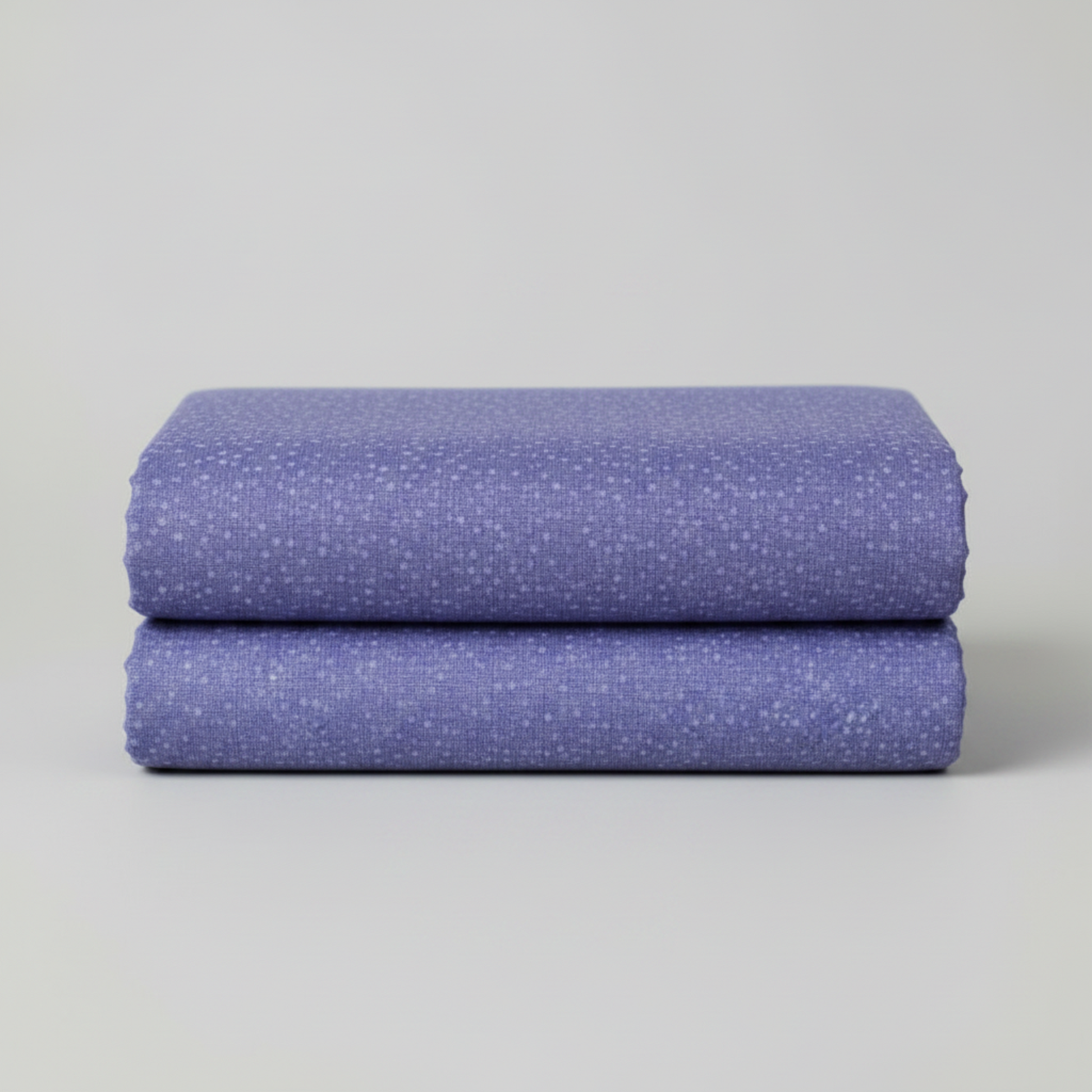 Dotty Thatched Periwinkle quilting cotton by Robin Pickens for Moda Fabrics neatly folded in a stack on a light grey background showing the dreamy periwinkle-blue ground with scattered tonal dots. 100% cotton, 43–44" wide. Available at IraRobi Quilts