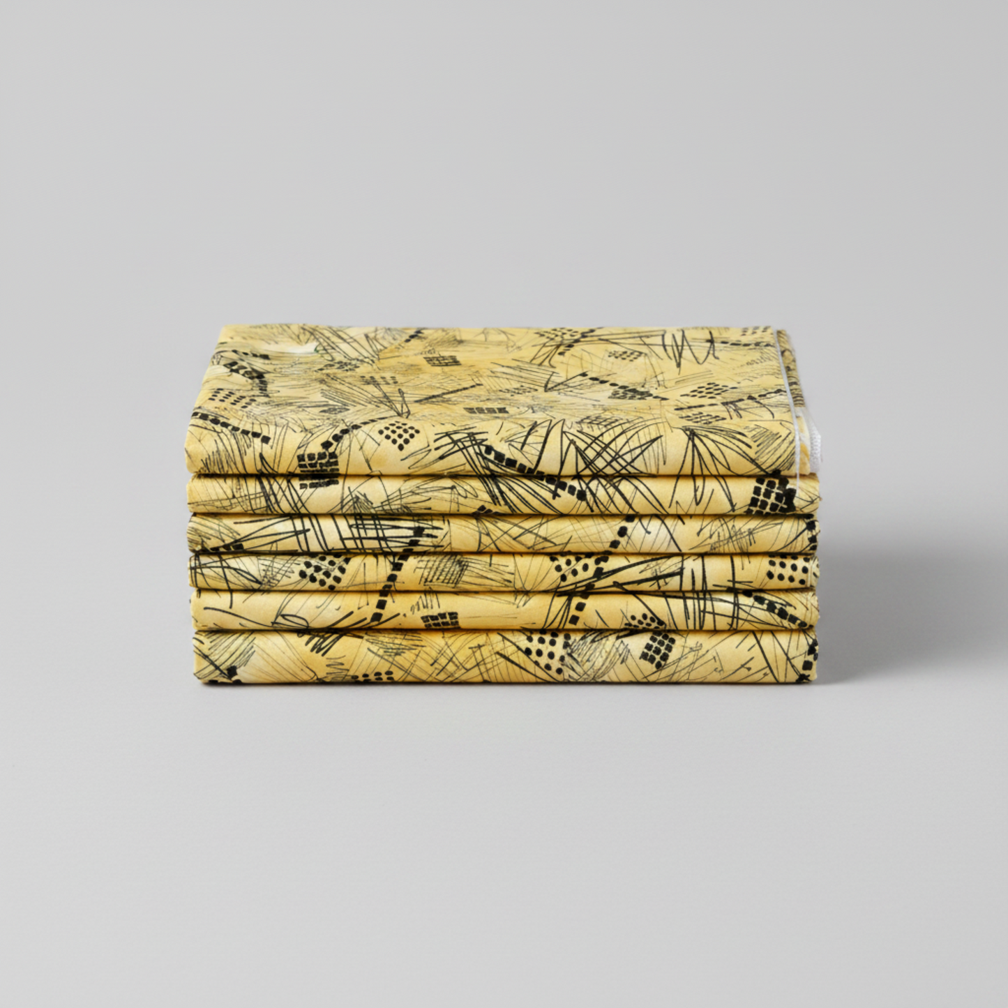 Heat Wave Bask Sun fabric folded and stacked — black abstract scratch lines, grid squares, and dot clusters on warm golden yellow quilting cotton by FreeSpirit Fabrics