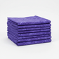 Expressions Batiks Hand-Dyes Purple II quilting cotton neatly folded and stacked, showing rich jewel-tone violet-purple color – by Riley Blake Designs