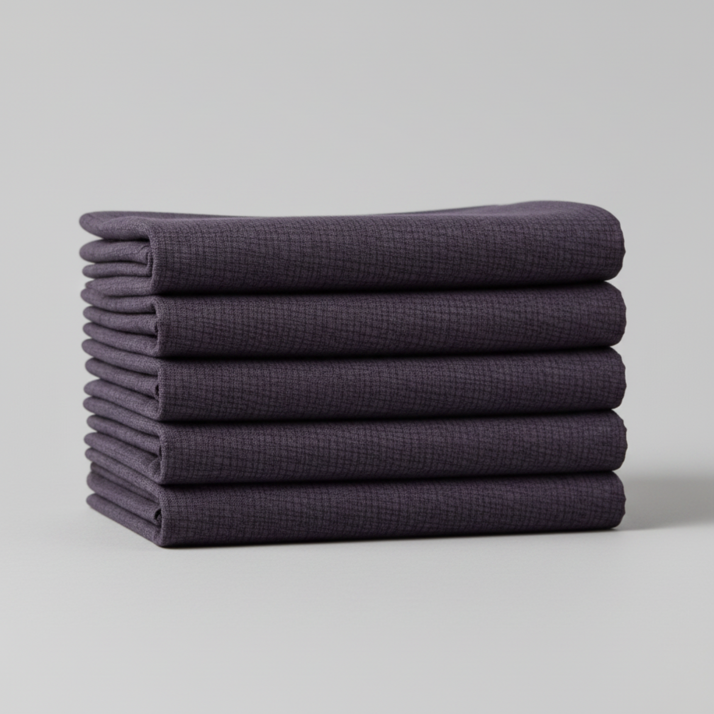 Thatched Shadow deep purple fabric by Robin Pickens for Moda Fabrics – neatly folded to show fabric texture and color depth. Coordinating fabrics and quilt patterns are available at IraRobi Quilts.