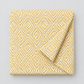 Lazy Afternoon Golden fabric folded with one corner turned back, showing the golden geometric maze print on a cream ground.