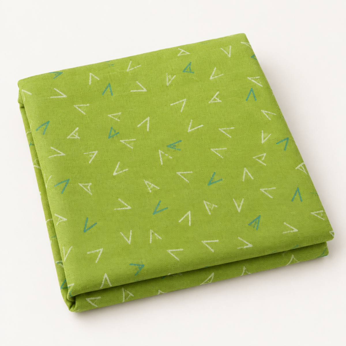 Folded Olive You Arrows Leaf fabric showing white and blue-green arrow marks on leaf green, photographed against a light background.