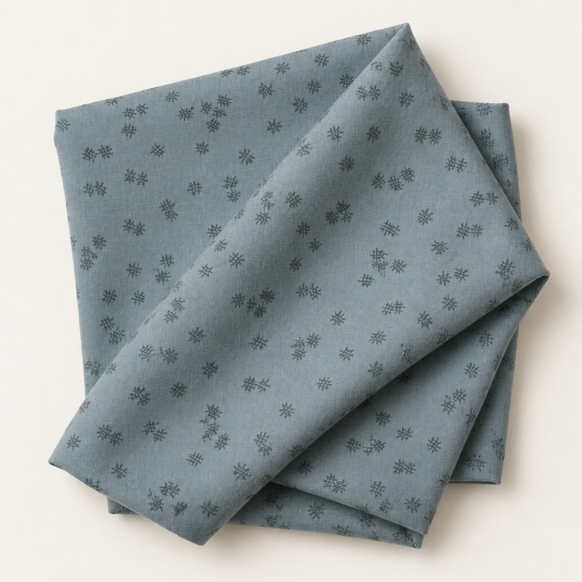 Folded Steel Crosshatch Bolt B fabric by Zen Chic for Moda Fabrics, showing the steel blue-gray print with scattered dark crosshatch marks against a light background.