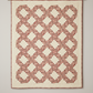 Fox Homestead Pink Leaves and Berries fabric by Stacy West for Henry Glass — quilt shown for inspiration features an interlocking geometric block pattern in dusty rose, muted burgundy, and olive-khaki tones on a warm cream background, displayed on a wall.