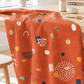 Frisky Catch Me Cheeky fabric by Zen Chic for Moda Fabrics draped over a wooden sewing table in a bright studio with thread, pins, and scissors. Available at IraRobi Quilts.