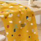Frisky Catch Me Sunny fabric by Zen Chic for Moda Fabrics draped over a wooden sewing table in a bright studio with thread, a pin dish, and scissors. Available at IraRobi Quilts.