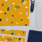 Frisky Catch Me Sunny fabric by Zen Chic for Moda Fabrics laid flat with cut strips, a rotary cutter, a clear quilting ruler, and a folded navy coordinating fabric. Available at IraRobi Quilts.
