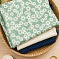 Frisky Floating Chill folded in a basket with cream and navy solids
