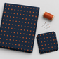 Frisky In A Row Moody fabric by Zen Chic for Moda Fabrics folded beside a stack of cut squares, a spool of rust-orange thread, and pins on a light grey background.